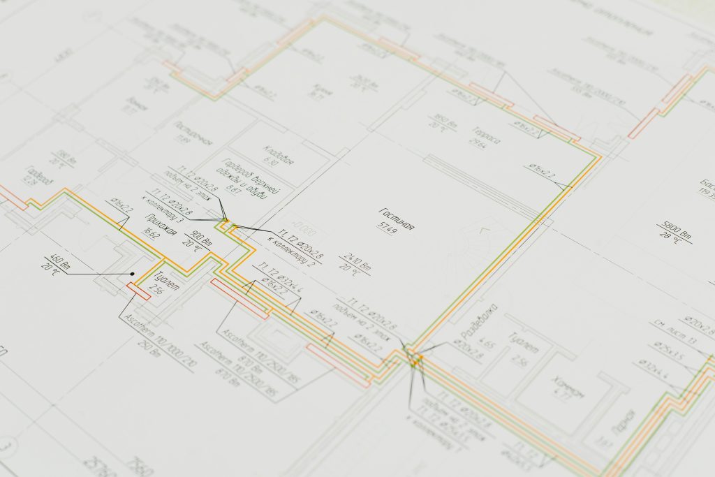 Close-up of a detailed architectural blueprint showing design plans on a desk. Ideal for construction and design concepts.